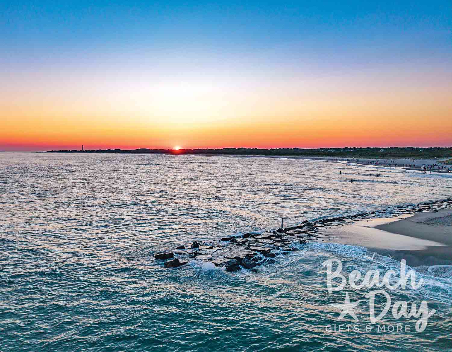 March: Sunset over the water beside a rocky jetty in Cape May, New Jersey