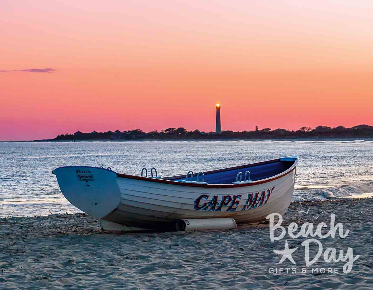 May: Cape May fishing boat on the beach with the lighthouse in the distance at sunset