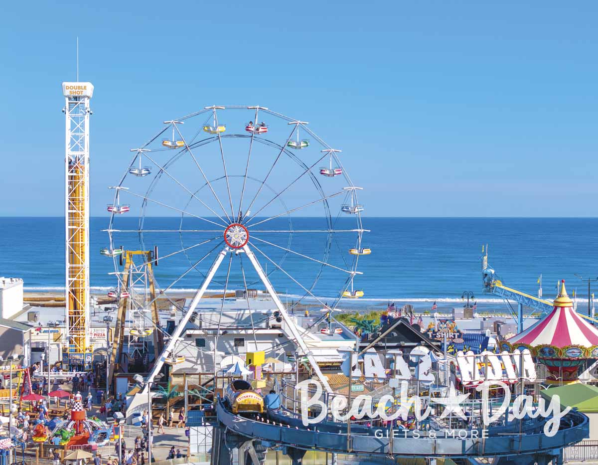 Ferris wheel and amusement rides on the Ocean City NJ Boardwalk overlooking the Atlantic Ocean