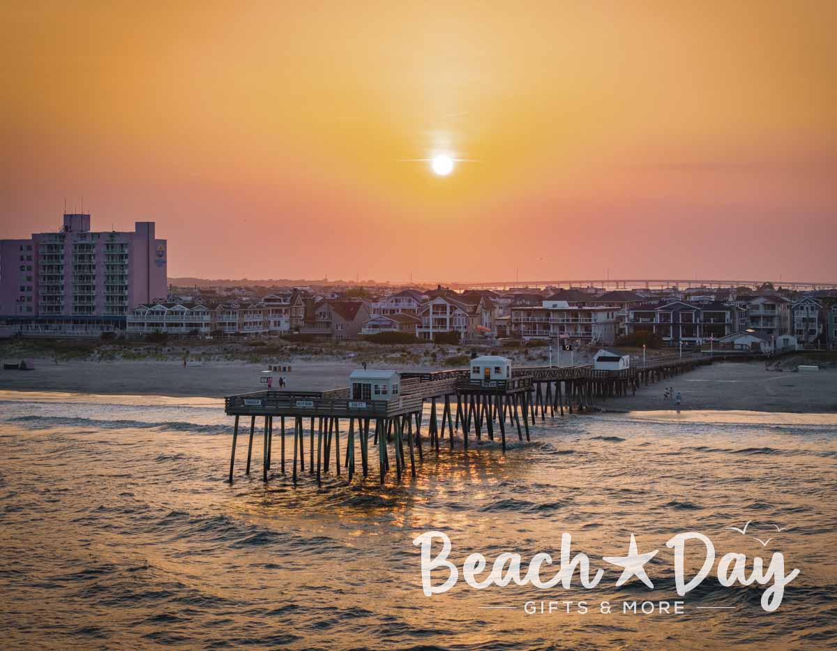 Ocean City NJ fishing pier over the ocean beneath a colorful sunset
