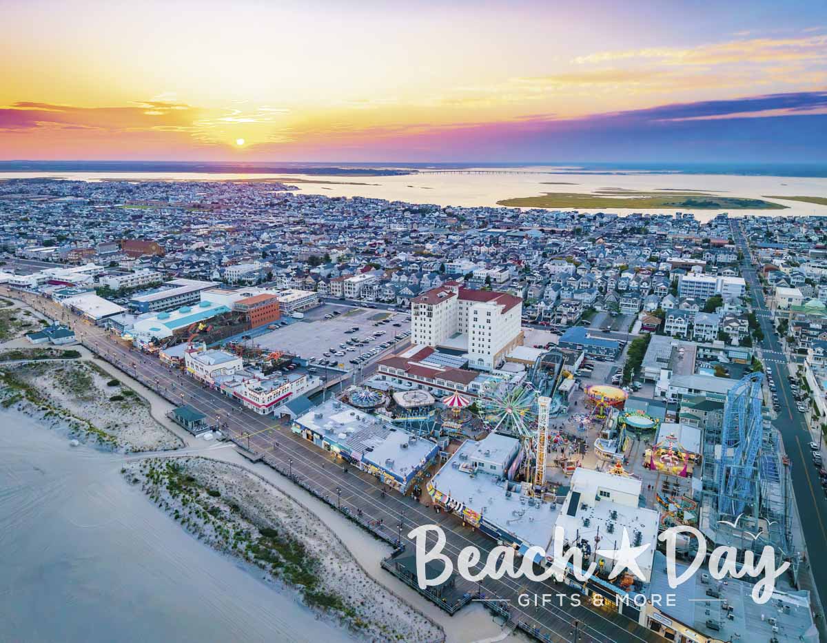 Aerial sunset view of the Ocean City NJ Boardwalk, amusement rides and surrounding island